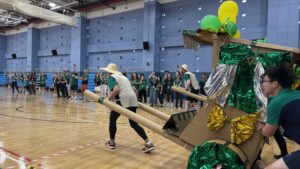 Team building a cardboard rickshaw together during Flat Out Rickshaw Rally